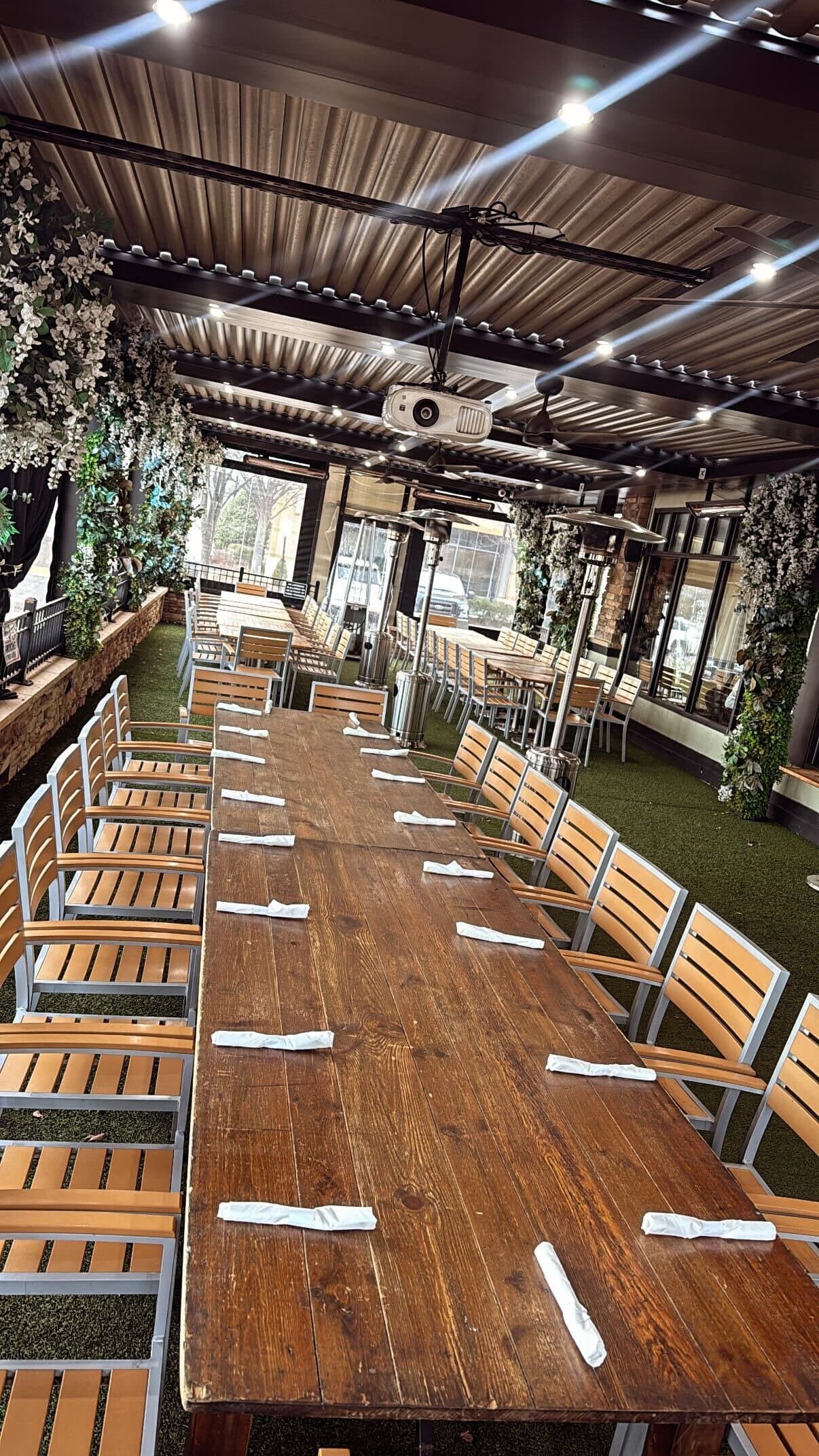 Long banquet table set for a private party on Rockwood's patio