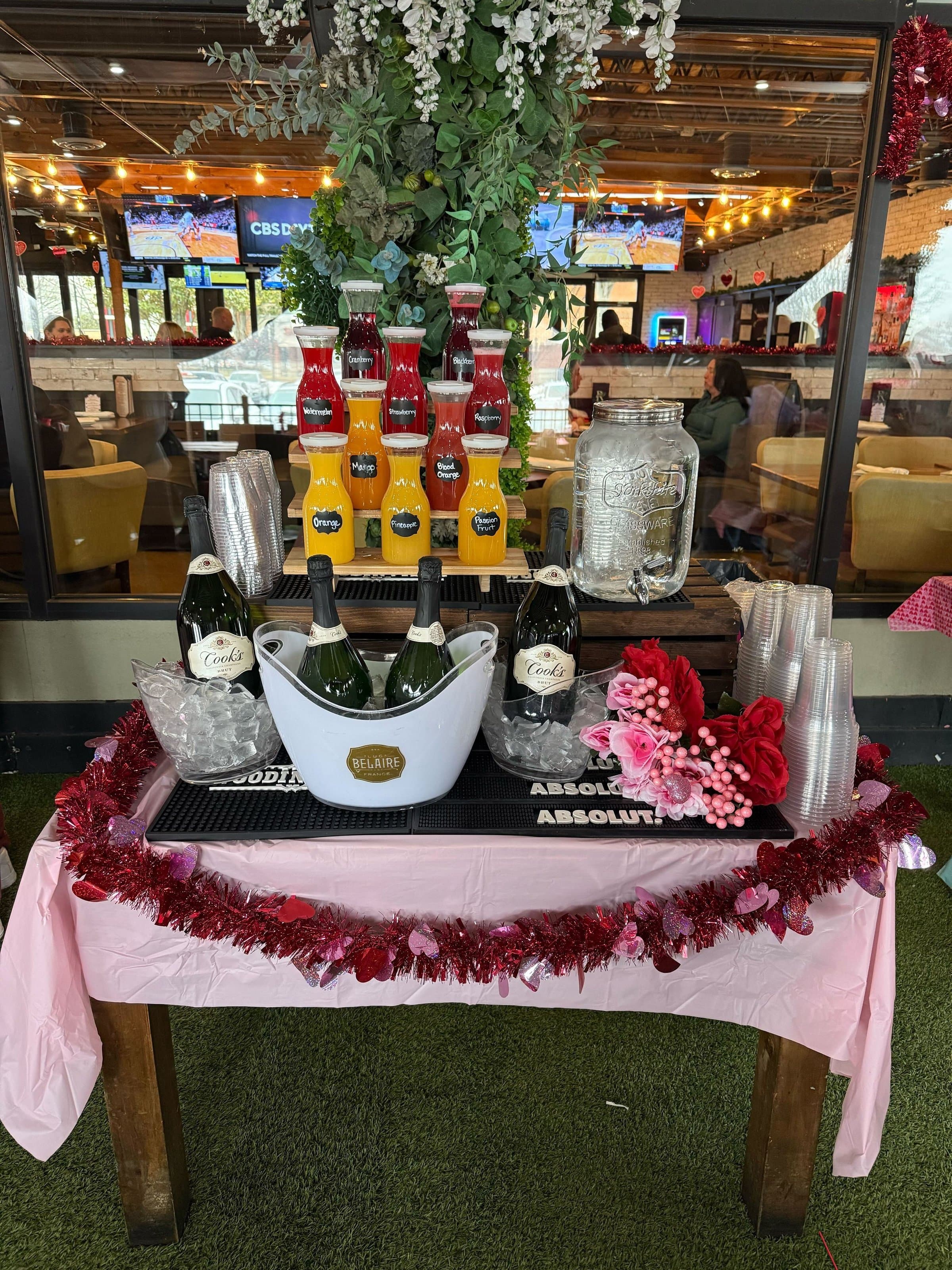 Mimosa bar with juices and sparkling wine set up for a private event at Rockwood