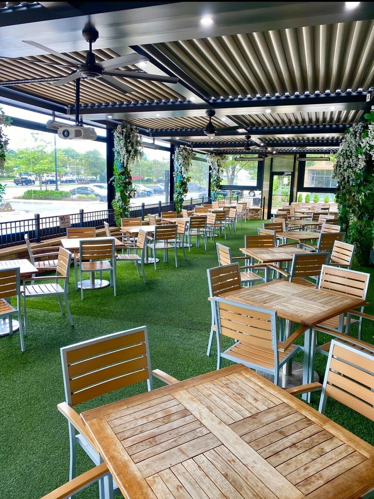 Rockwood's covered patio with turf floor and wood tables, Gainesville VA